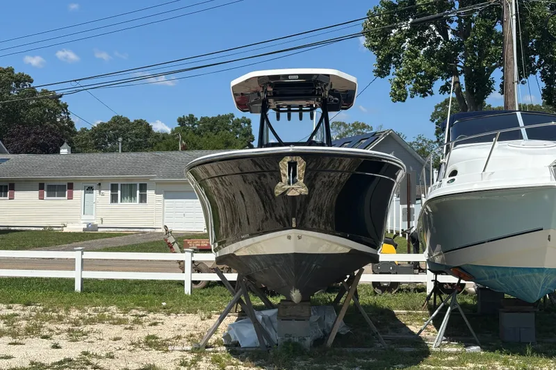 Slide: The Image of 2020 Blackfin 242 CC boat on stands, residential background, sunny day. - 4