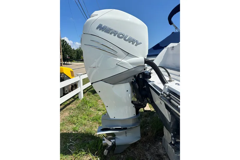 Slide: The Image of 2020 Blackfin 242 CC boat with Mercury outboard engine, parked on grass. - 24