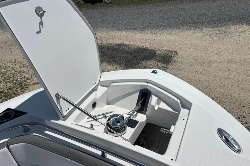 Slide: The Image of Open anchor compartment on 2020 Blackfin 242 CC boat, showcasing storage and chain mechanism. - 22