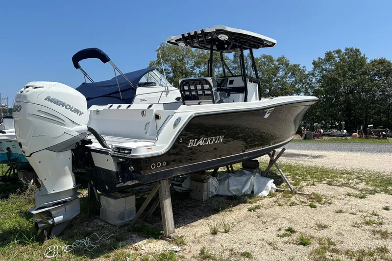 Slide: The Image of 2020 Blackfin 242 CC boat with Mercury engine on dry land. - 3