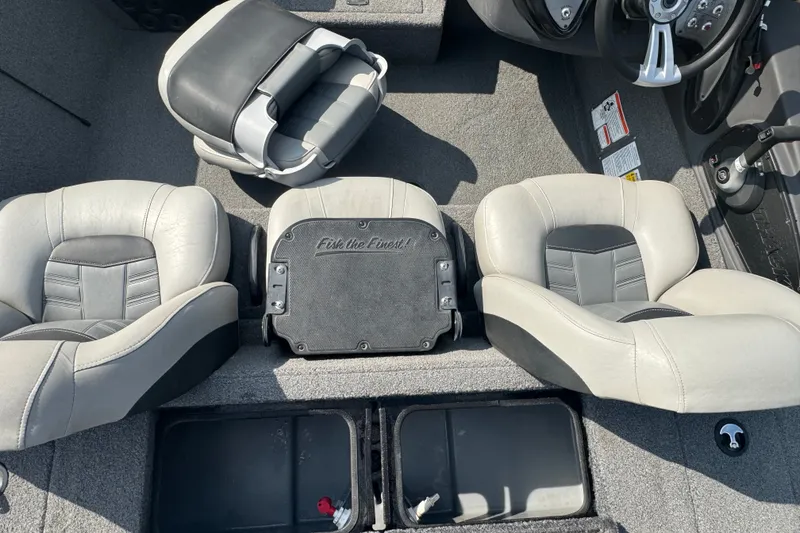 Slide: The Image of Interior of 2018 Tracker Pro Team 195 TXW boat with gray seating and steering wheel. - 17