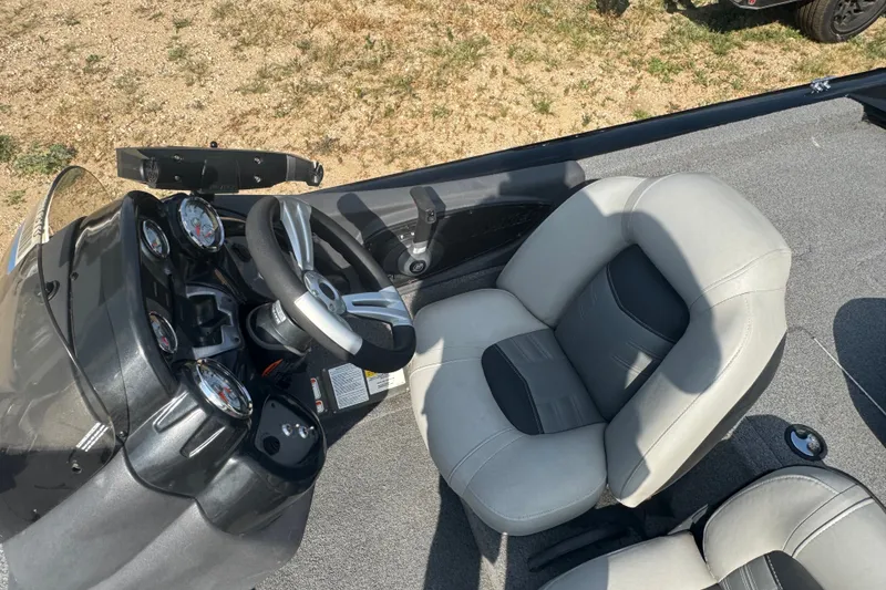 Slide: The Image of 2018 Tracker Pro Team 195 TXW boat interior with steering wheel and seat. - 14