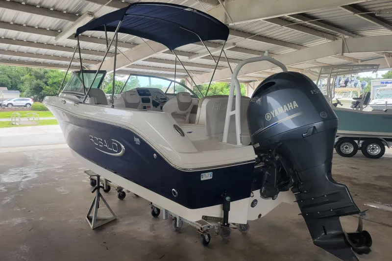 Slide: The Image of 2020 Robalo R207 Dual Console boat with Yamaha outboard motor in covered storage. - 1