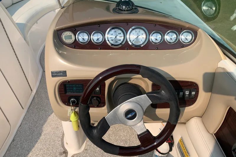 Slide: The Image of Dashboard of a 2003 Chaparral Sunesta 236 boat with gauges and steering wheel. - 3