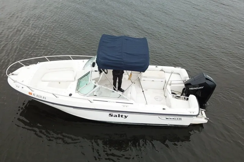Slide: The Image of 1998 Boston Whaler 20 Ventura Bowrider with canopy on calm water. - 4