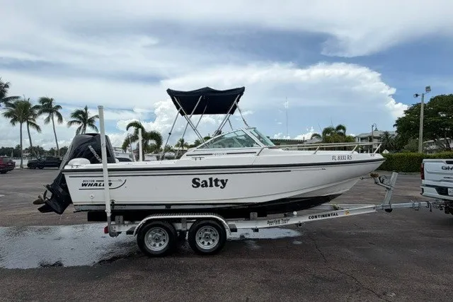 Slide: The Image of 1998 Boston Whaler 20 Ventura Bowrider on trailer, named "Salty," parked outdoors. - 15
