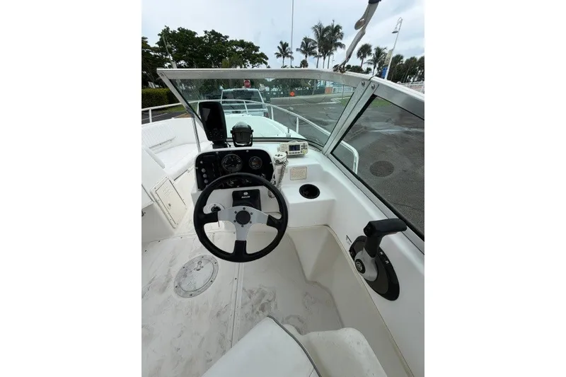 Slide: The Image of 1998 Boston Whaler 20 Ventura Bowrider cockpit with steering wheel and control panel. - 10