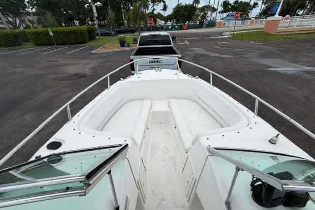 Slide: The Image of 1998 Boston Whaler 20 Ventura Bowrider on trailer, parked in lot with GMC truck. - 11