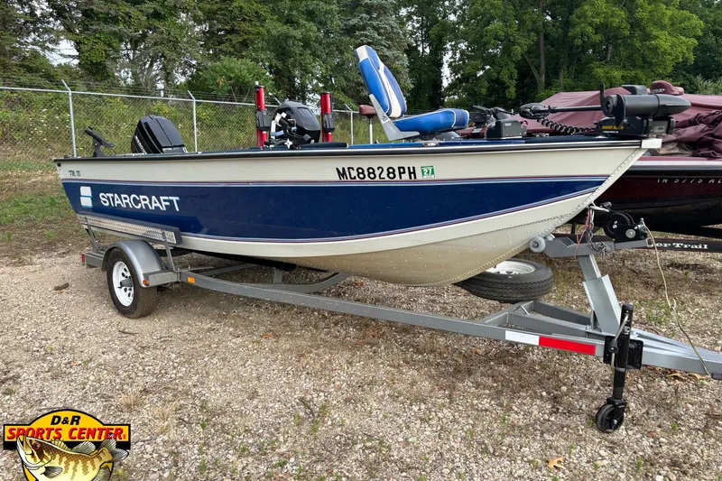 The Image of 1991 Starcraft Super Fisherman 170 boat on trailer, parked outdoors. - 1