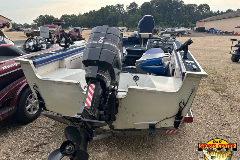 Slide: The Image of 1991 Starcraft Super Fisherman 170 boat with outboard motor, parked outdoors at D&R Sports Center. - 3