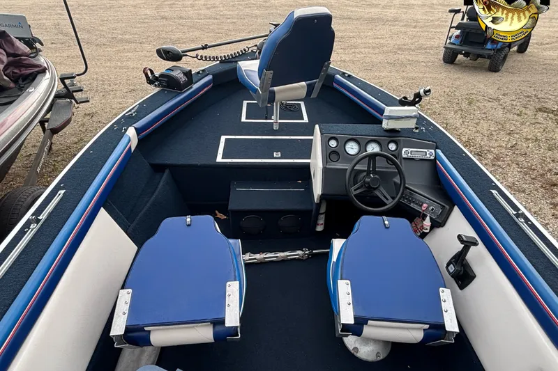 Slide: The Image of 1991 Starcraft Super Fisherman 170 boat interior with blue seating and steering console. - 6