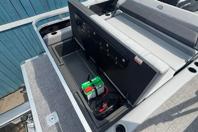 Slide: The Image of 2026 Sun Tracker Party Barge 22 RF XP3 storage compartment with battery and seating. - 18