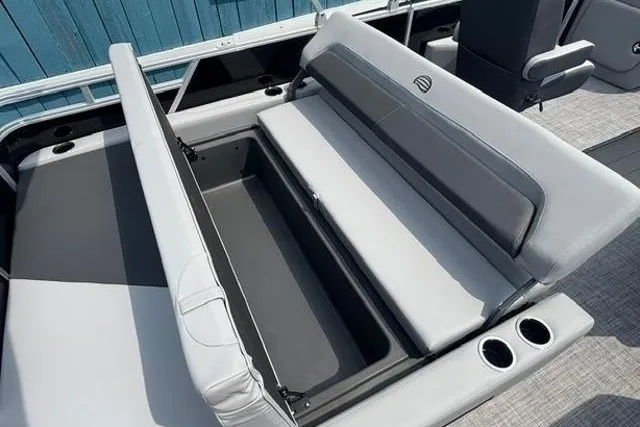 Slide: The Image of 2026 Sun Tracker Party Barge 22 RF XP3 with open storage compartment and cup holders. - 17