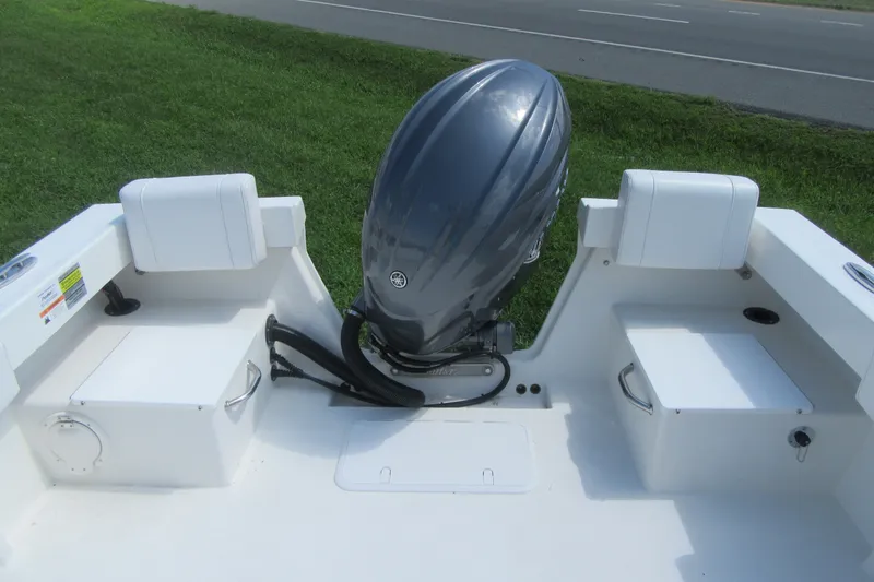 Slide: The Image of 2027 Parker 217 Explorer boat with outboard motor, white seating, and storage compartments. - 5