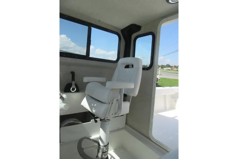 Slide: The Image of Interior of 2027 Parker 217 Explorer boat with white captain's chair and windows. - 18