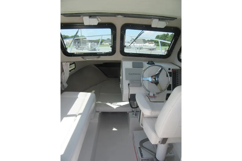 Slide: The Image of Interior of 2027 Parker 217 Explorer boat with steering wheel and Garmin navigation system. - 11