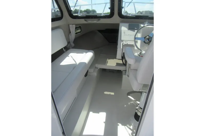 Slide: The Image of Interior of 2027 Parker 217 Explorer boat with seating and steering console. - 14