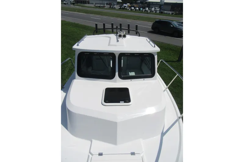 Slide: The Image of 2027 Parker 217 Explorer boat with sleek white deck and cabin windows. - 10