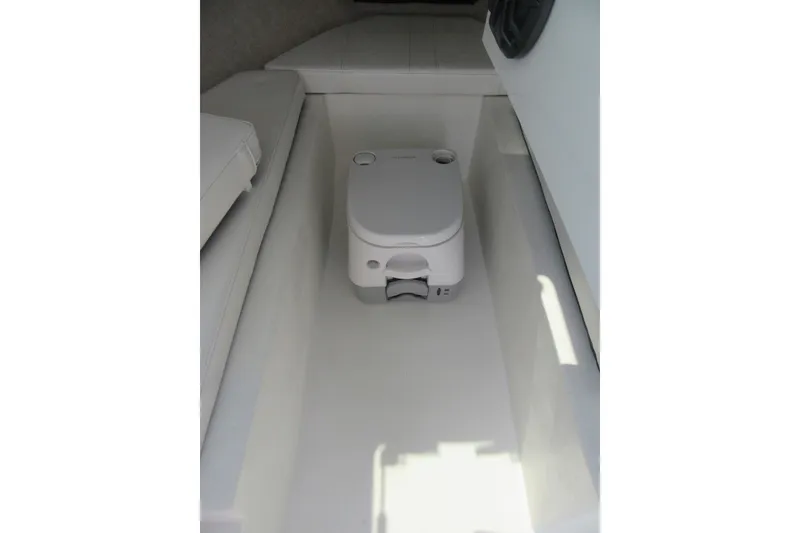 Slide: The Image of Compact toilet in the cabin of a 2027 Parker 217 Explorer boat. - 15