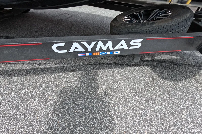 Slide: The Image of 2021 Caymas trailer with spare tire on asphalt surface. - 36