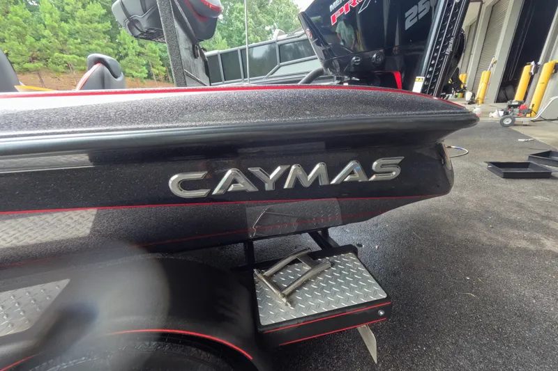 Slide: The Image of 2021 Caymas boat with metallic finish and step ladder, parked outdoors. - 14
