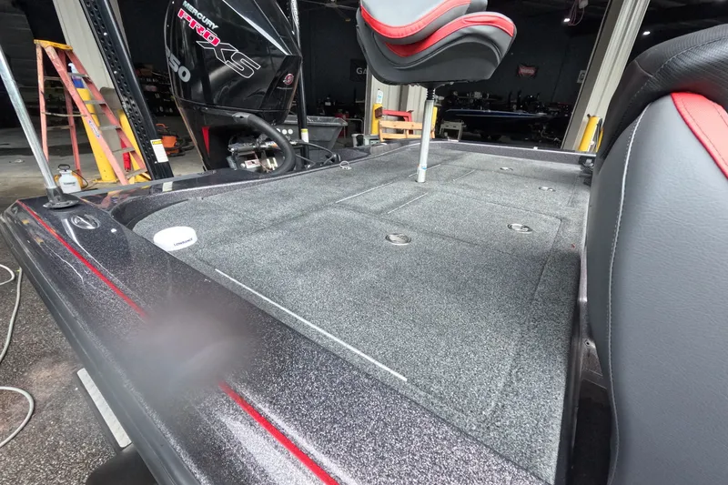 Slide: The Image of 2021 Caymas boat interior with Mercury Pro XS engine, featuring a sleek, carpeted deck and seating. - 7