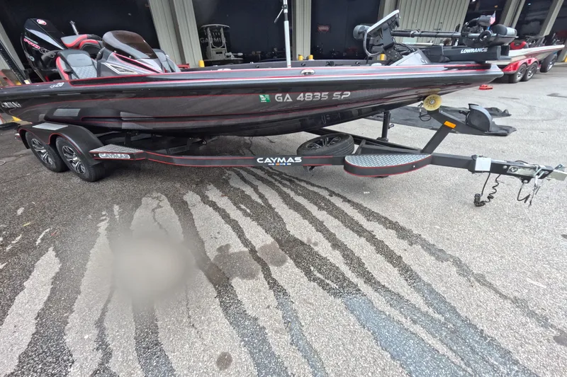 Slide: The Image of 2021 Caymas boat on trailer, featuring sleek design and modern equipment. - 2