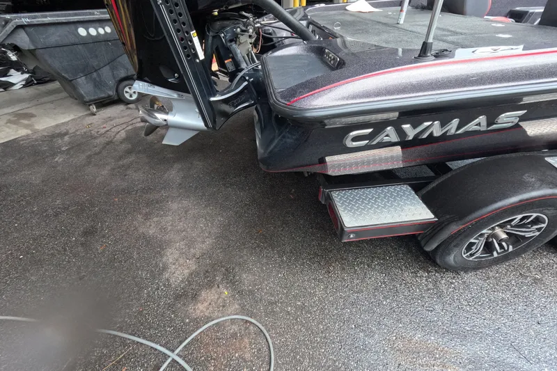 Slide: The Image of 2021 Caymas boat rear view with trailer, featuring sleek design and metallic accents. - 18