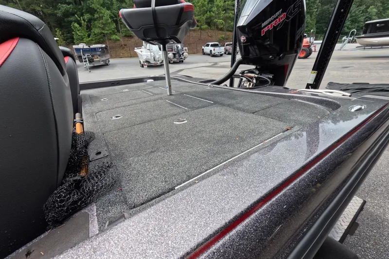 Slide: The Image of 2021 Caymas boat deck with Mercury Pro XS engine in a marina setting. - 27