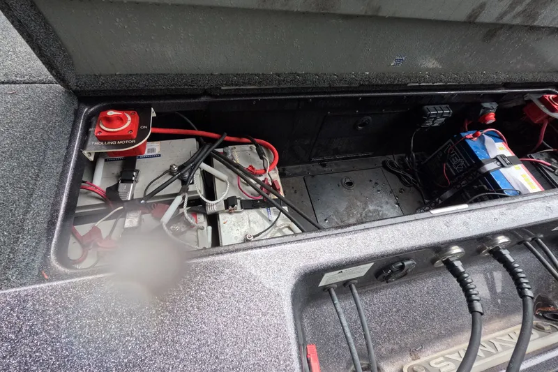 Slide: The Image of 2021 Caymas boat battery compartment with wiring and trolling motor switch. - 10