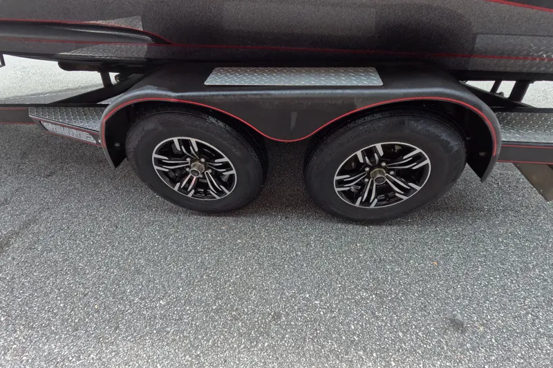 Slide: The Image of 2021 Caymas trailer with dual black alloy wheels on asphalt. - 28