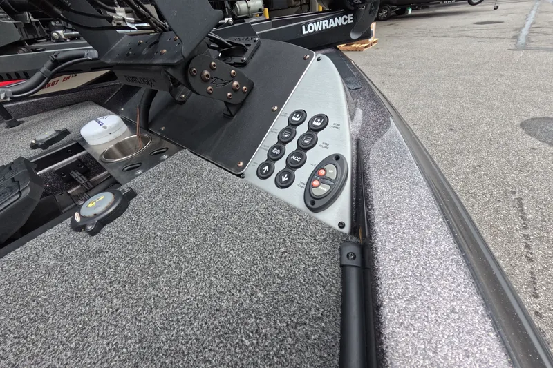 Slide: The Image of 2021 Caymas boat control panel with buttons and Lowrance equipment on textured surface. - 23