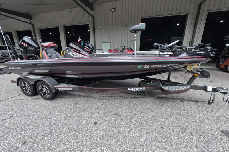 Slide: The Image of 2021 Caymas boat on trailer, parked outside a building. - 20
