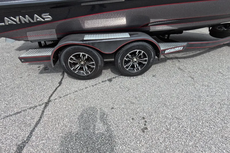 Slide: The Image of 2021 Caymas boat trailer with dual black alloy wheels on asphalt. - 35