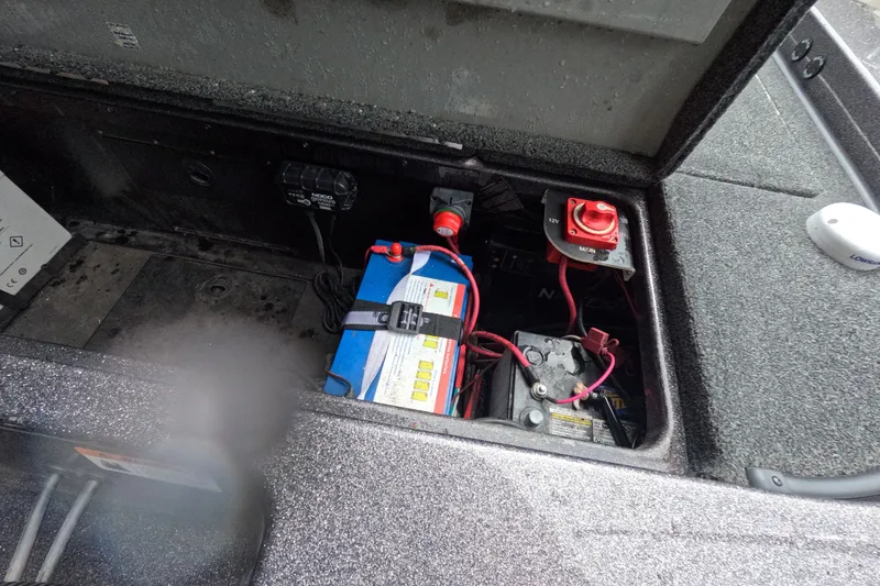 Slide: The Image of 2021 Caymas boat battery compartment with wiring and switch. - 11