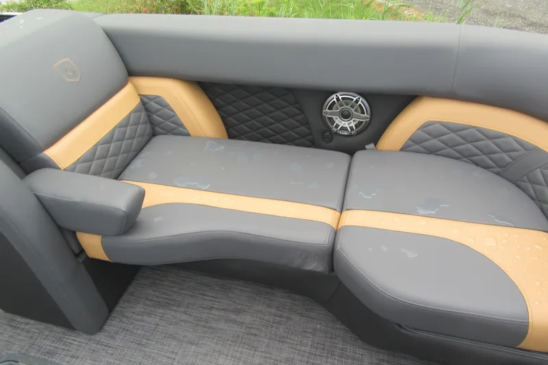 Slide: The Image of Luxurious seating on 2027 Godfrey Monaco 235 ULC boat, featuring gray and tan upholstery with speaker. - 6