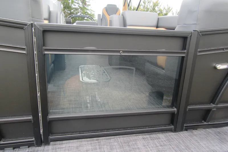 Slide: The Image of 2027 Godfrey Monaco 235 ULC pontoon boat interior with sleek black paneling. - 18
