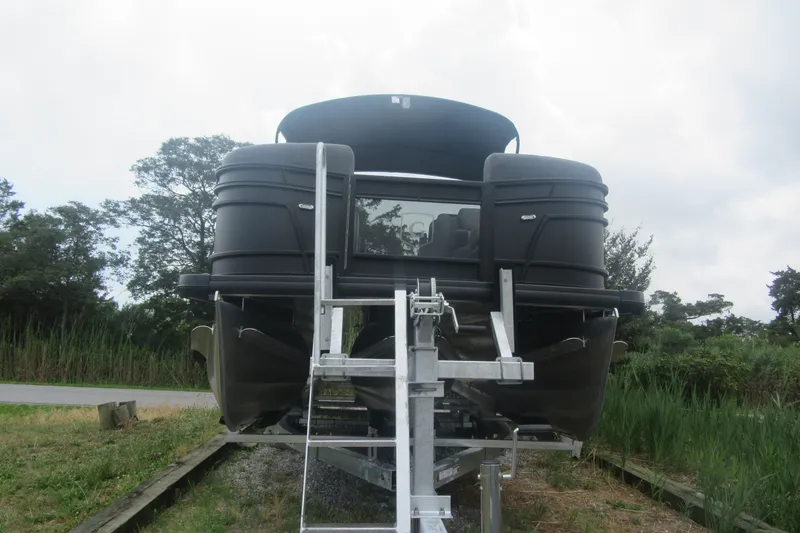 Slide: The Image of 2027 Godfrey Monaco 235 ULC pontoon boat on trailer, viewed from the front. - 2