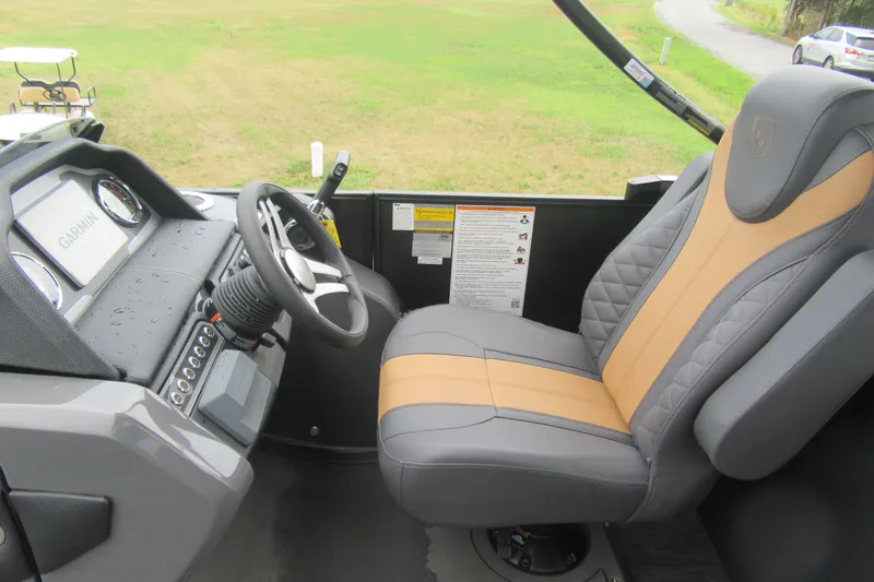 Slide: The Image of Captain's seat and dashboard of 2027 Godfrey Monaco 235 ULC boat, featuring Garmin navigation. - 8