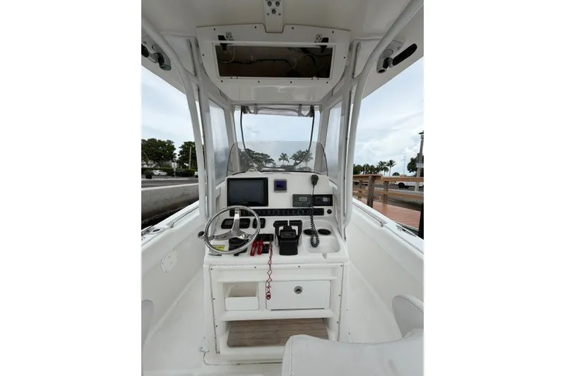 Slide: The Image of 2014 Sea Hunt Gamefish 25 boat cockpit with steering wheel and navigation equipment. - 10