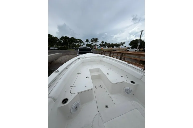 Slide: The Image of 2014 Sea Hunt Gamefish 25 boat interior with spacious deck and storage compartments. - 11