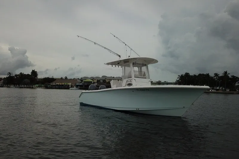 Slide: The Image of 2014 Sea Hunt Gamefish 25 boat on calm water under cloudy skies. - 4