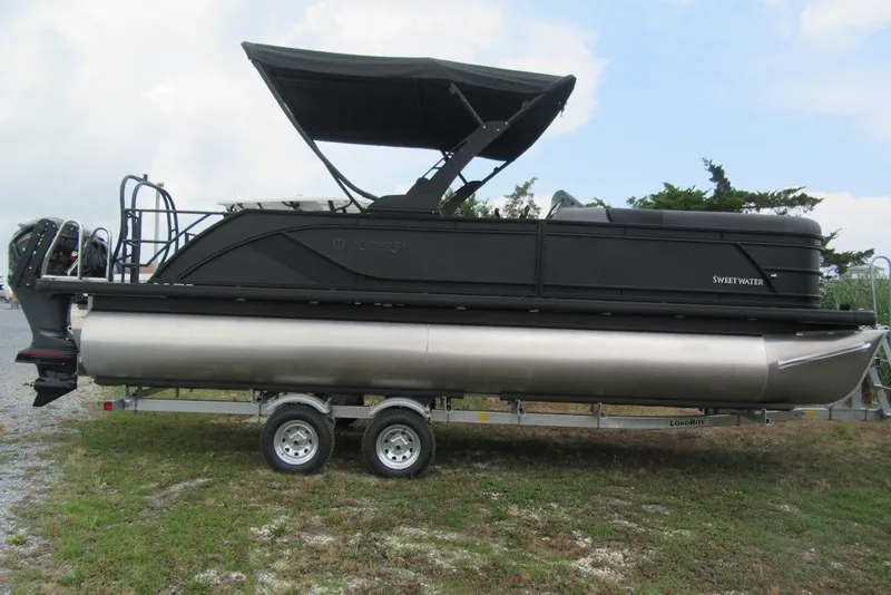 The Image of 2027 Godfrey Sweetwater 2286 SFLC pontoon boat on trailer, featuring sleek black design. - 1