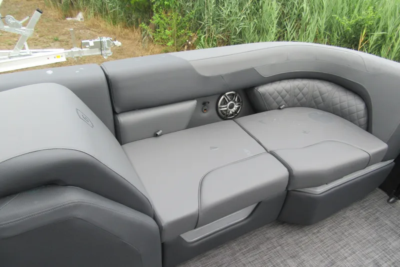 Slide: The Image of 2027 Godfrey Sweetwater 2286 SFLC boat interior with gray cushioned seating and speaker. - 6