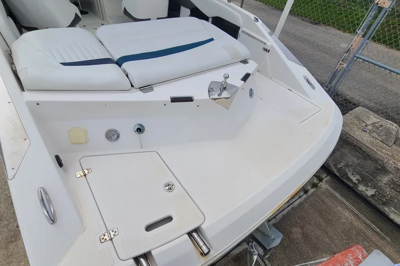 Slide: The Image of 2005 Regal 2200 Bowrider boat interior with white seating and deck details. - 18