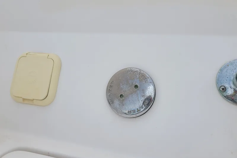 Slide: The Image of 2005 Regal 2200 Bowrider water inlet and access panel on white surface. - 17