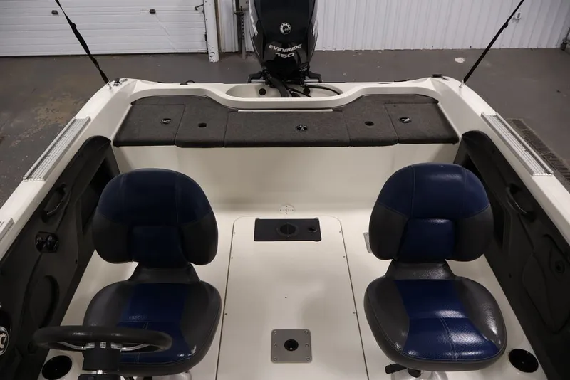 Slide: The Image of 2012 Ranger 1860 Angler boat interior with dual seats and Evinrude motor. - 19