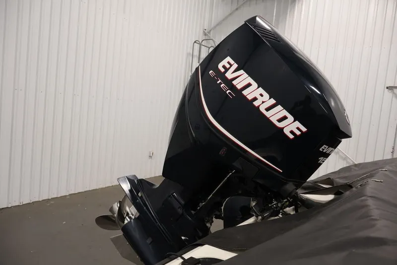 Slide: The Image of 2012 Ranger 1860 Angler with Evinrude E-TEC outboard motor in a garage. - 32