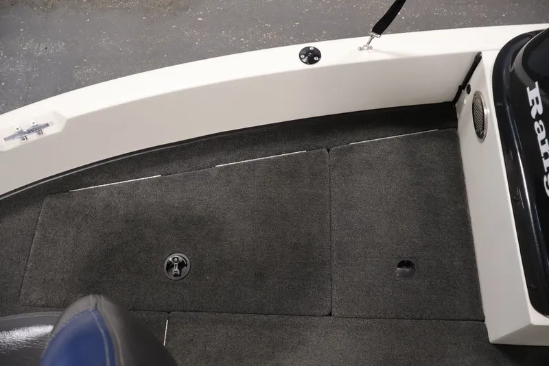 Slide: The Image of 2012 Ranger 1860 Angler boat interior with carpeted flooring and storage compartments. - 9