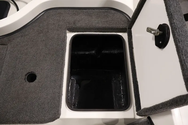 Slide: The Image of Open storage compartment in 2012 Ranger 1860 Angler boat, featuring carpeted interior. - 35